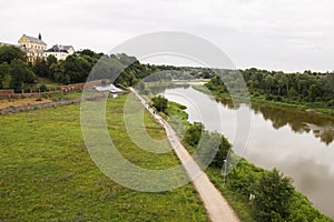 A view of the bank of the Bug river with the town of Drohiczyn on the hilltop