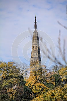 The view of Baochu Pagoda in West Lake with autumn trees in the foreground.