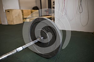 Close up view of barbell on floor in gym