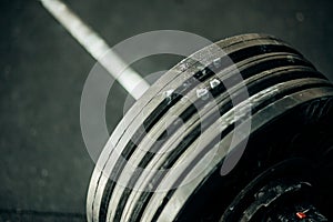 Close up view of barbell on floor in gym