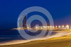 View of Barcelona Beach in summer night along seaside in Barcelona, Spain. Mediterranean Sea in Spain.