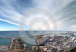 View of barcelona docks and harbour with shipping containers being loaded, warehouses grain silos and railway lines