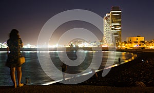 Barceloneta beach with Mapfre tower and Arts Hotel in night photo