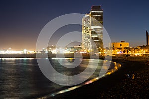 Barceloneta beach with Mapfre tower and Arts Hotel in night photo