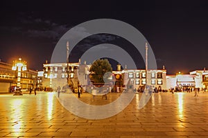 A view on Barkhor square and Barkhor square and Jokhang temple glowing with gold lights at night, Lhasa Tibet
