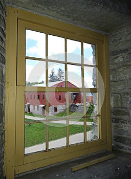 Window view of Tannery from inside Shaker Round Stone Barn