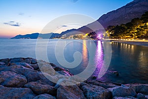 View on Baska Voda town at evening with Biokovo mountains in Dalmatia in Croatia