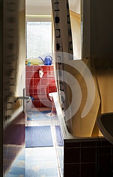 View of bathroom of cheap and affordable apartment with sunlight from glass window