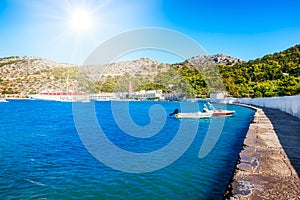 View of bay with boats and Monastery of Taxiarchis Mihail Panormitis on Island of Symi  Rhodes, Greece