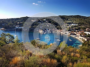 View of the bay of Paxos with yachts and the sun