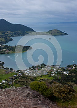 A view at the bay with the sea and family houses from the Mt. Manaia near Whangarei in the North Island on New Zealand