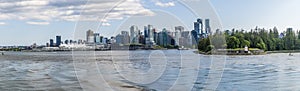 A view from the bay towards Stanley Park and Canada Place in Vancouver, Canada