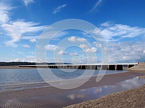 View of the beach at arnside with the leven railway viaduct and river in the south lakes area of cumbria