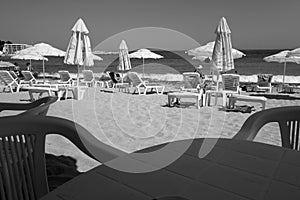View on the beach from the bar table in black and white
