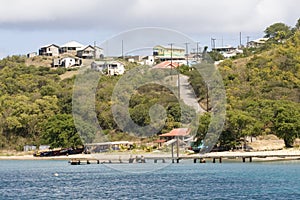View of Beach, Boats, Jetty and Houses; Saline Bay, Mayreau Island, Saint Vincent and the Grenadines, Eastern Caribbean.