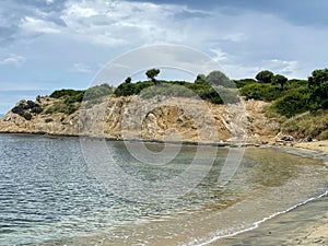 View from the beach in Sarti, with crystal clear, blue water and clouds
