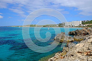 View on the beach Son Bou and white boat on the Balearic Island Menorca, Spain