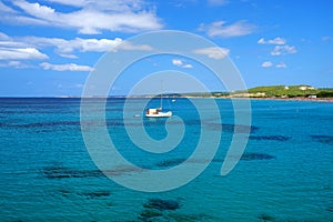 View on the beach Son Bou and white boat on the Balearic Island Menorca, Spain