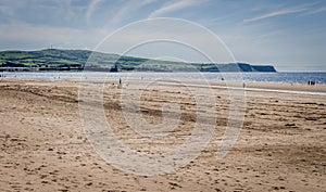 A view on the beach of tourists enjoying the summer sun