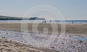 A view on the beach of tourists enjoying the summer sun