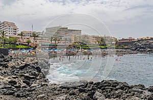 View of the beach town of Puerto de Santiago in the foreground lava volcanic formations