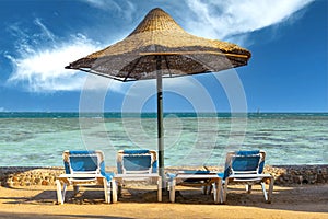 View of the beach with umbrellas and sun beds, the red sea, Hurgada, Egypt photo