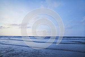 View of beach and waves at sunrise