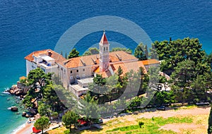 View of beautiful bay with beach and Dominican monastery in Bol town, Brac island, Croatia. Dominican monastery in Bol, built in