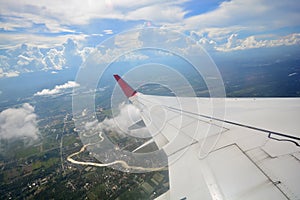 View of beautiful cloud and wing of airplane from window, South