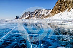 View of beautiful drawings on ice from cracks and bubbles of deep gas on surface of Baikal lake in winter, Russia