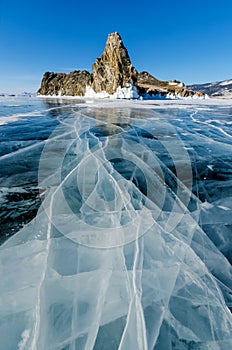 View of beautiful drawings on ice from cracks and bubbles of deep gas on surface of Baikal lake in winter, Russia