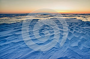 View of beautiful drawings on ice from cracks and bubbles of deep gas on surface of Baikal lake in winter, Russia