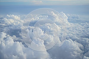 View of beautiful free form heaven cloud with shades of blue sky background from flying plane window