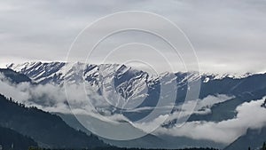 View of beautiful glacier, mountains with fog and cloudy weather in manali