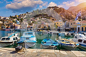 View of the beautiful greek island of Symi Simi with colourful houses and small boats. Greece, Symi island, view of the town of