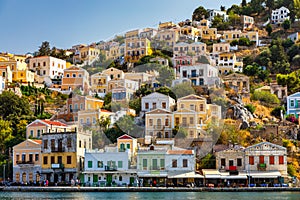 View of the beautiful greek island of Symi Simi with colourful houses and small boats. Greece, Symi island, view of the town of