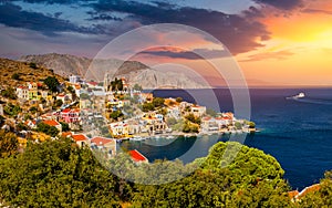 View of the beautiful greek island of Symi Simi with colourful houses and small boats. Greece, Symi island, view of the town of