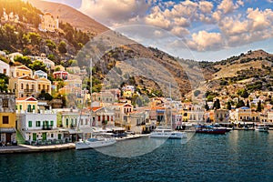 View of the beautiful greek island of Symi Simi with colourful houses and small boats. Greece, Symi island, view of the town of