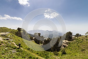 View of beautiful green scenery and mountain ridges at Hatu Peak of Narkanda town, Himachal Pradesh.