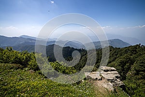 View of beautiful green scenery and mountain ridges at Hatu Peak of Narkanda town, Himachal Pradesh.