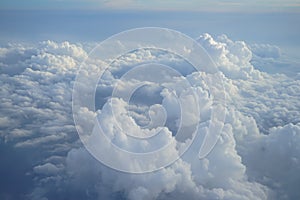 View of beautiful heaven cloudscape with shades of blue sky background from flying plane window