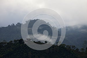 View of beautiful hills on a foggy day in Orosi, Costa Rica photo