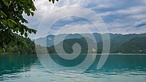 View of beautiful Lake Bled Blejsko Jezero with the Pilgrimage Church of the Assumption of Maria on a small island and Bled Cast