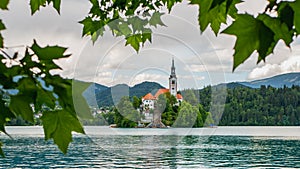 View of beautiful Lake Bled Blejsko Jezero with the Pilgrimage Church of the Assumption of Maria on a small island and Bled Cast