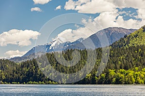 View of a beautiful lake with mountains in the background in sunny summer day