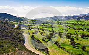 View of beautiful landscape with fresh green meadows and mountain tops in the background on a sunny day with blue sky