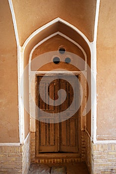 View of a beautiful old Iranian door on the walls of an old house in Yazd, Yazd has a unique Iranian architecture.