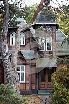 A view of a beautiful old wooden house in the middle of the forest.