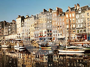 View of the beautiful port of Honfleur, France with boat reflections