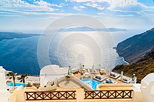 A view of beautiful sea and caldera with luxury hotel buildings, typical white architecture of Santorini island, Greece